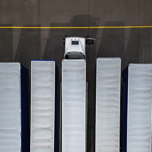 Truck parked next to trailers, top-down view