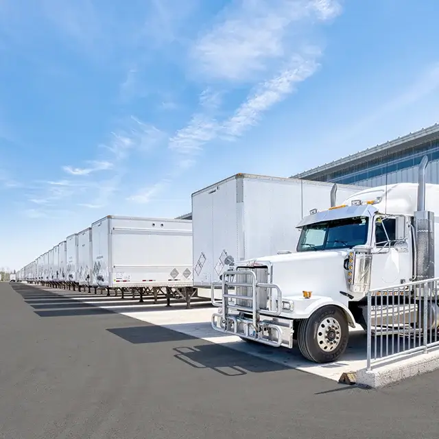 White semi-truck and trailers parked in lot