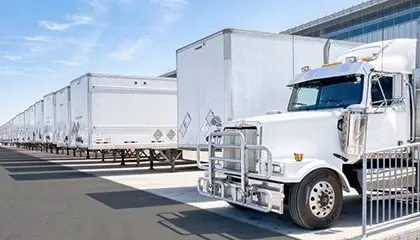 White semi-truck parked at loading dock