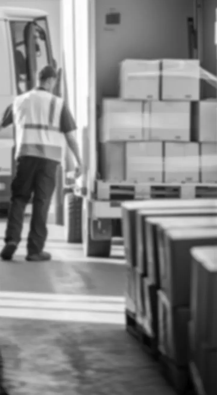 Delivery worker loading boxes onto a truck